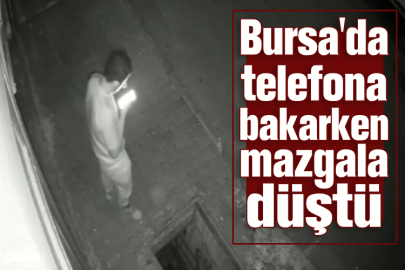 Bursa'da telefona bakarken mazgala düştü